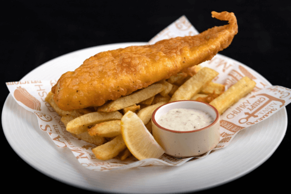 A plate of fish and chips with tartar sauce